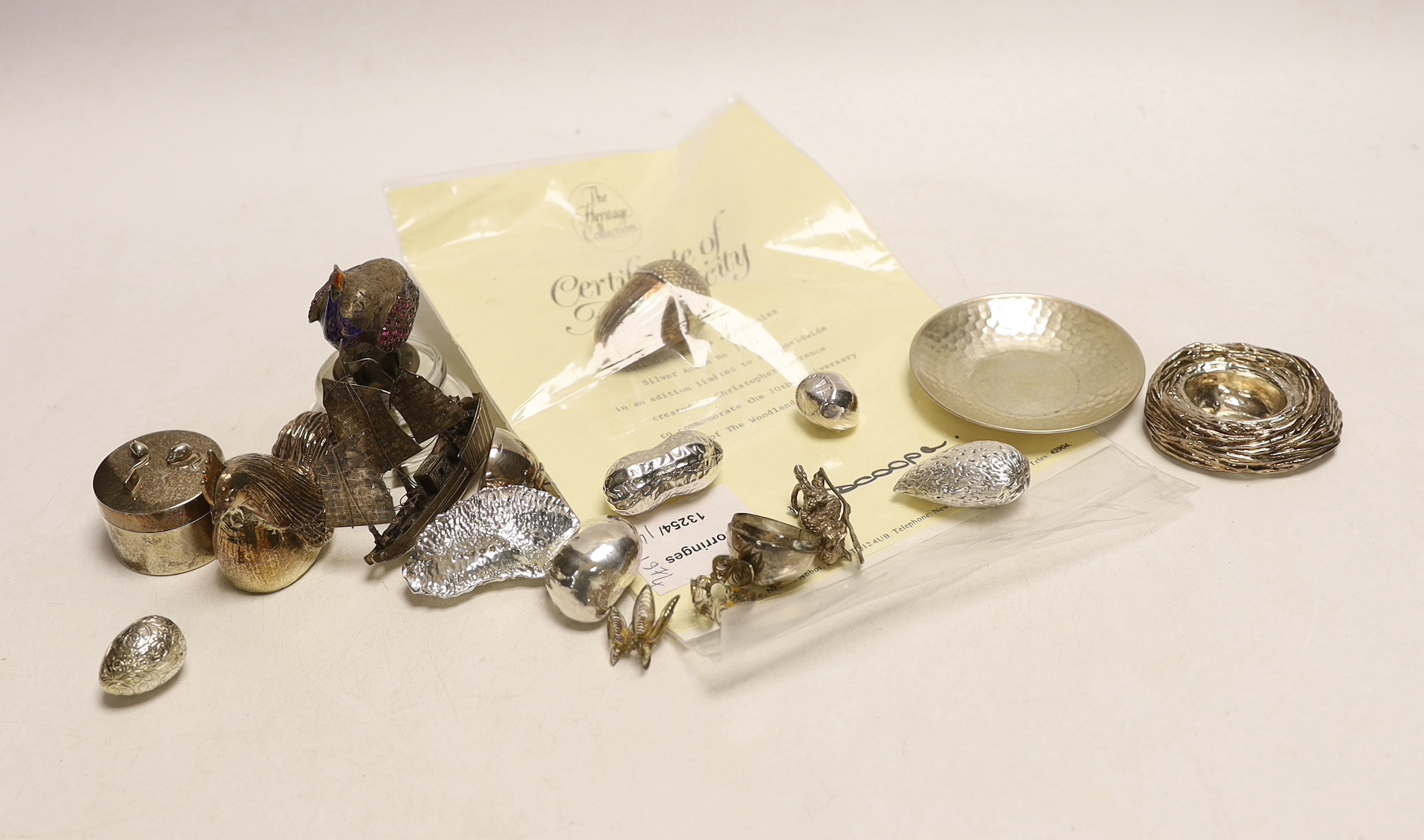 A group of modern novelty silver and white metal items including a limited edition surprise acorn by Christopher Nigel Lawrence, London, 1983, opening to reveal two squirrels, 43mm, with certificate, four novelty silver